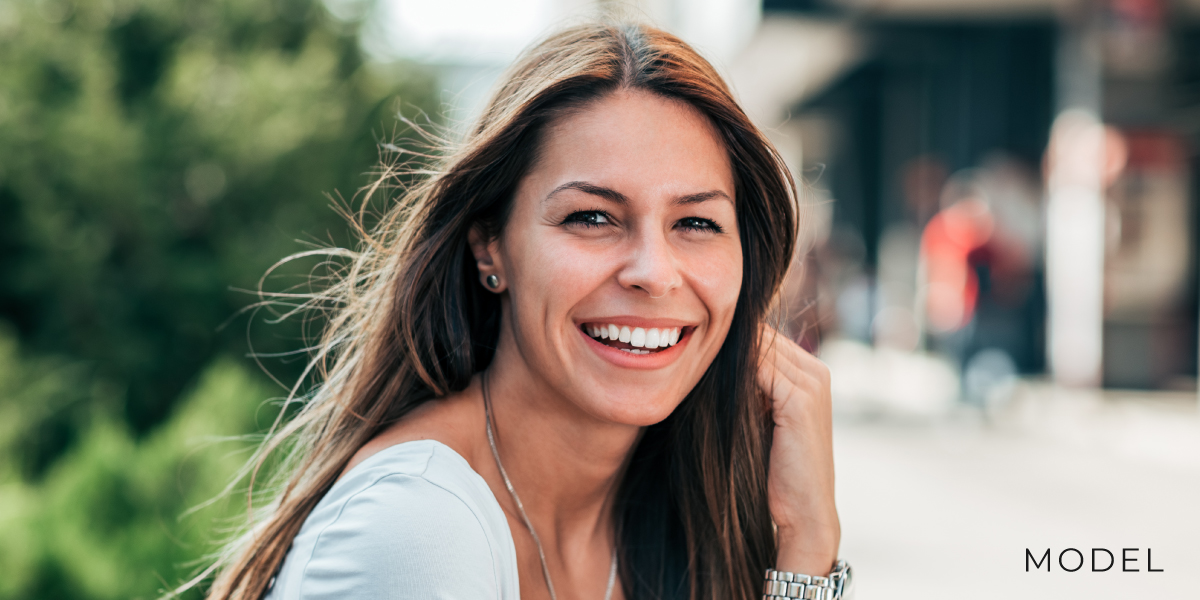 Smiling model outdoors chattanooga periodontics dental implants