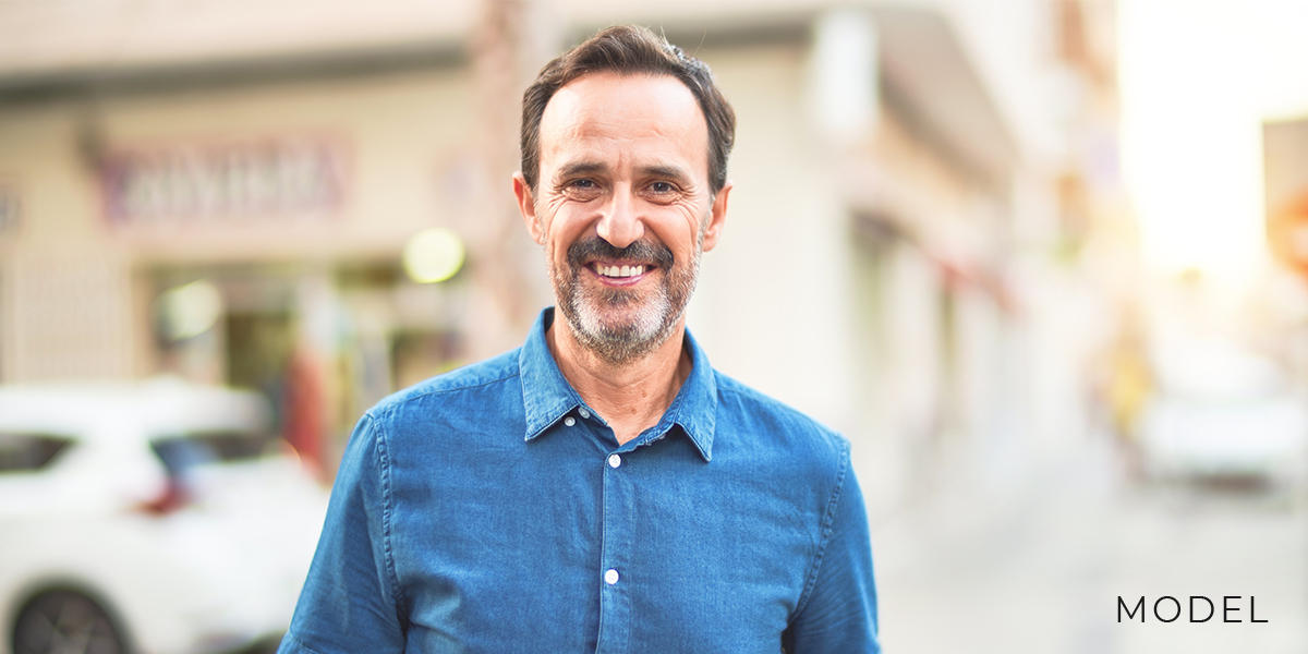 Male model in blue shirt for snap-on dentures.