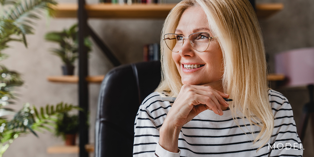 Model with blonde hair in a verdant living room  chattanooga periodontics  dental implants